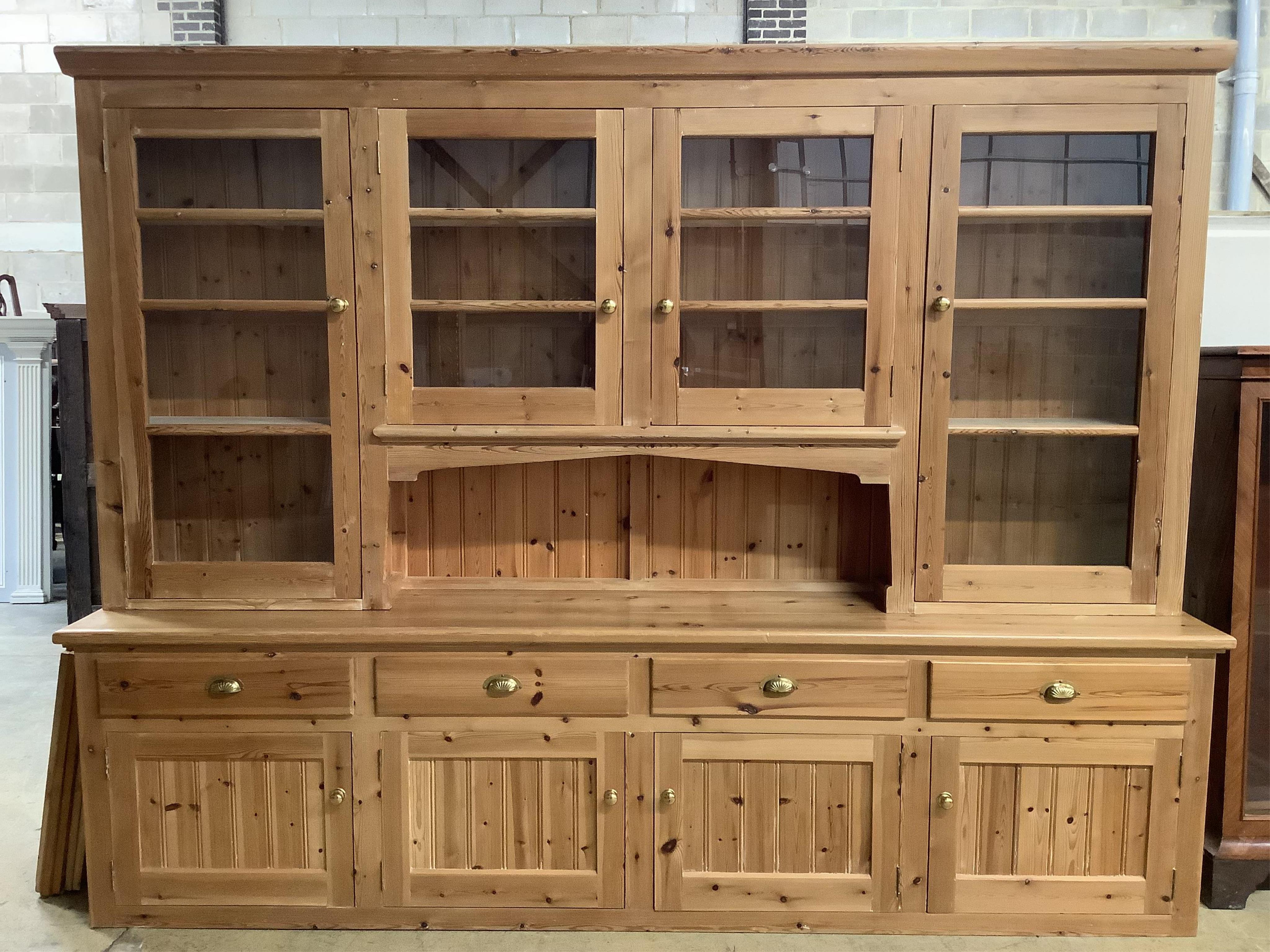 A large modern pine dresser, width 280cm, depth 53cm, height 216cm. Condition - fair